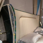 Cream Upholstered Bed with Decorative Accent Trim, Brand Emblem & Gold Stainless Steel Feet